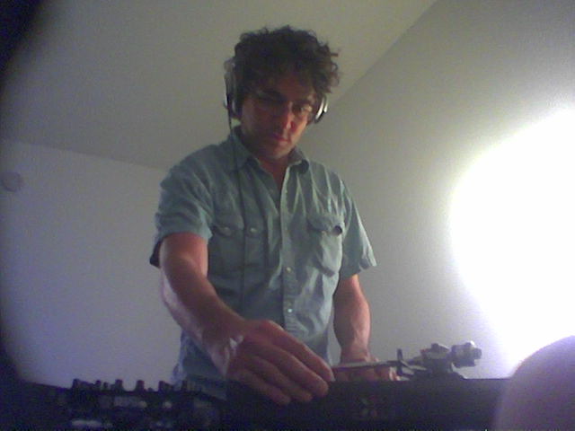 DJ Ben spins frenetically and intensely, kicking off sounds of DJ Ben and the Shitheads